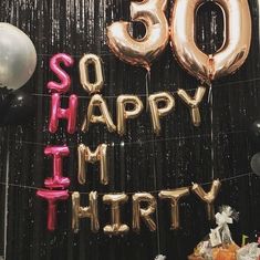 balloons and streamers in the shape of letters that read'50, happy birthday '