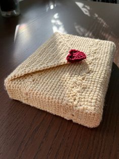 a crocheted pouch sitting on top of a wooden table