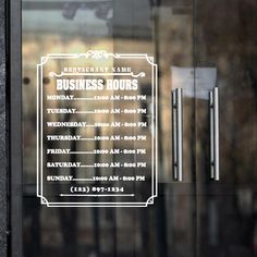 a business hours sign is on the glass door