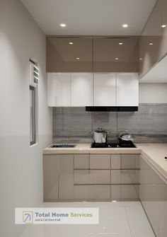 a modern kitchen with white cabinets and beige counter tops, along with stainless steel appliances