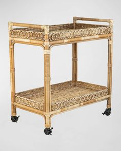 a wicker serving cart with wheels on the top and bottom, made of bamboo