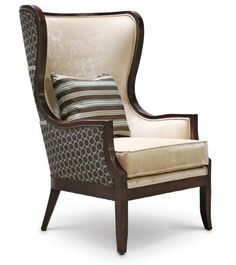 an upholstered chair with a striped pillow on the back and armrests