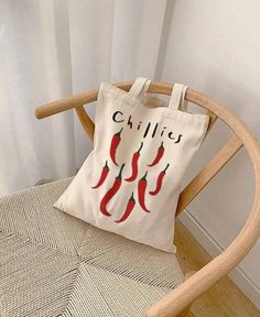 a tote bag sitting on top of a wooden chair