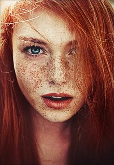 a red headed woman with freckles on her face