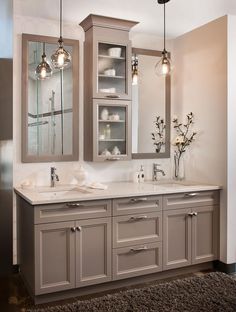 a bathroom with double sinks and two mirrors on the wall next to eachother