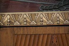 a close up of a wooden door with decorative designs on it