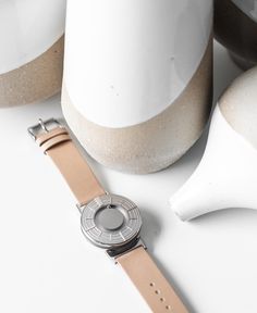 A photo of the watch lying flat on a surface. The recessed track around the outside of the watch face is shown with the hour ball bearing in the track. The raised markers are noticeable from this perspective. Silver Watch With Metal Dial For Everyday Use, Silver Watch With Leather Strap For Everyday, Silver Watches With Leather Strap For Everyday, Silver Modern Watch For Everyday, Modern Silver Watches For Everyday Use, Modern Silver Watch Accessories For Everyday, Modern Silver Watches For Everyday, Modern Watch Accessories With Metal Dial For Everyday Use, Modern Everyday Watches With Bracelet Strap