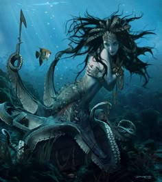 a woman with long hair sitting on top of an octopus in the ocean next to a fish