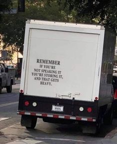 a white box truck driving down a street