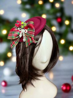 Plaid Bow and Berries Christmas Fascinator Introducing the Plaid Bow and Berries Christmas Fascinator by The Head Mistress ! Elevate your holiday look with this exquisite fascinator designed to make you stand out during the festive season. Features a festive felted pillbox fascinator with clip. Main Features: Festive Elegance: Add a touch of Christmas spirit to your outfit with this eye-catching fascinator. Premium Quality: Crafted with high-quality materials for durability and a stylish appearance. Unique Design: Stand out at any Christmas event or gathering with this charming accessory. Affordable Luxury: Available at the lowest prices without compromising on quality. USA-Made: Designed, printed, and shipped from the USA for a seamless shopping experience. Ideal for holiday photography s Christmas Fascinator Diy, Winter Party Hats With Bow, Holiday Adjustable Fascinator, Christmas Fascinator, Pillbox Fascinator, Bow Fascinator, Fabric Photography, Christmas Event, Holiday Photography