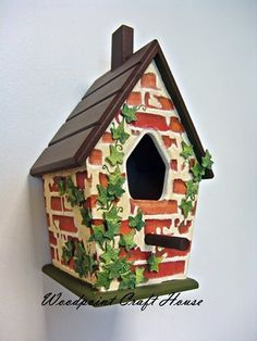 a birdhouse with ivy growing on the side of it's roof and chimney