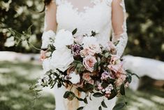 a bride holding a bouquet of pink and white flowers on her wedding day in the grass