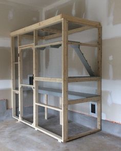 an empty room with several shelves in the middle and one on the floor, all made out of wood