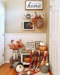 the entryway is decorated with pumpkins and fall decor