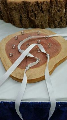 a piece of wood with white ribbon tied around it