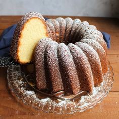 a bundt cake on a glass plate with a slice cut out