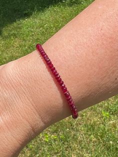 "This handmade women's bracelet is made with the finest quality natural (untreated) red rubies. This is the perfect gift for a July birthday. This bracelet is made just for you, and you can pick the size and finish.  **Please note that the pictures are magnified to show detail. This is a dainty bracelet. *I donate a portion of my sales to a Pug Rescue or charity.* *Ruby is the birthstone for July. *The natural (untreated) Ruby beads are approximately 3-4mm *The clasp and findings are sterling silver, gold-filled, or rose gold filled. *Your purchase will be sent in a gift box. *Please Note: My pictures are magnified to show detail.  -How to determine your bracelet size. STEP 1: Measure your wrist (where you would normally wear your bracelet) using a flexible measuring tape or a strip of pap Ruby Beaded Bracelets With Gemstone Beads As Gift, Gift Ruby Gemstone Beaded Bracelets, Adjustable Ruby Gemstone Bracelet, Ruby Beaded Bracelets With Round Beads For Gift, Ruby Beaded Bracelets As A Gift, Ruby Beaded Bracelets With Round Beads As Gift, Handmade Ruby Bracelets As Gifts, Red Rondelle Gemstone Beads Bracelets, Handmade Adjustable Ruby Bracelet