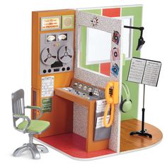 a model of a room with a desk, chair and radio on the floor in front of it