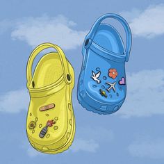 two children's clogs are shown against a blue sky