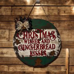 a sign that says christmas wishes and gingerbread kisses on the side of a wooden wall