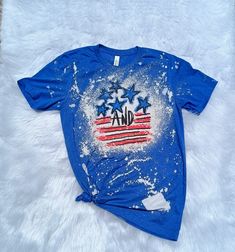 "American Stars And Stripes Bleached Shirt - Red White and Blue - Fourth of July Bleached Tee - Red White Blue Tee - Bleached Shirt - Bleached Shirt - Vintage Tee T-Shirt was made using our Heather Royal Shirt Bleach style and pattern may vary ** Shirt Colors ** Heather Red Heather Royal ** Shirt Sizes  ** S M L XL XXL *Shirt Details* 4.5 oz. 65% polyester 35% cotton Semi-fitted Seamless double needle 3/4\" collar Taped neck and shoulders Rolled forward shoulder Double needle sleeve and bottom h Blue T-shirt With American Flag Print For Spring, Red Distressed Short Sleeve T-shirt, Patriotic Blue Cotton Tops, Blue Cotton Patriotic Tops, Patriotic Red Shirt For Spring, 4th Of July Blue Cotton Shirt, Blue Cotton Shirt For 4th Of July, Blue Cotton Patriotic Shirt, Blue Relaxed Fit Top With American Flag Print