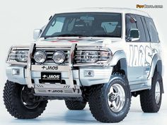 a white truck parked on top of a white floor