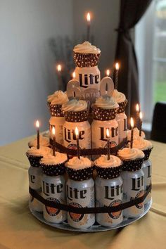 a cake made out of beer cans with lit candles