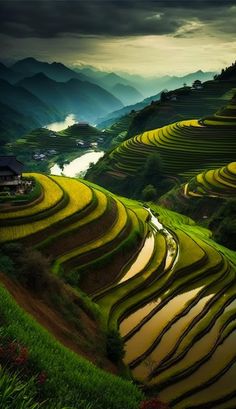 an image of rice terraces in the mountains with houses on top and water running through them