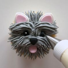 a close up of a toothbrush with a dog's head on the wall