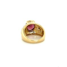 Vintage 6 Carat Pinkish Red Oval Cut Tourmaline Ring. Set in 18K Yellow Gold, this semi-precious gemstone ring weighs 11.5 grams and styles the a retro era look.  The exquisite oval-cut tourmaline, with a charismatic blend of pink and red hues, bears excellent luster and color distribution. Enhanced by the brilliance of 0.40 carats in round cut diamonds in both classic white and dramatic black, elegantly bezel-set, this ring is a harmonious symphony of colors and design.   Item Details: - Type: Luxury Oval Ruby Ring With Gemstone, Yellow Gold Tourmaline Ring, Yellow Gold Tourmaline Ring With Polished Finish, Formal Ruby Ring With Oval Cabochon Center Stone, Formal Ruby Ring With Oval Cabochon, Formal Tourmaline Ring With Bezel Setting, Formal Tourmaline Rings With Bezel Setting, Fine Jewelry Yellow Gold Tourmaline Rings, Oval Gemstone Dome Ring In Yellow Gold