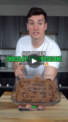 a man is holding a chocolate cake in front of the camera with words above it