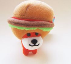 a small stuffed animal with a hamburger on it's head