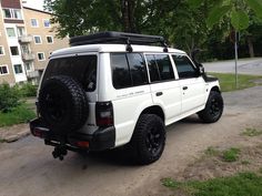 a white suv parked on the side of a road