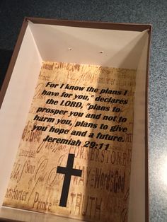 a wooden cross in a box with words written on the inside and below it that reads, for i know that prayer have for you, john