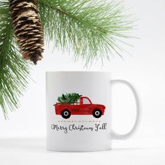 a red truck with a christmas tree on the back is parked under a pine cone