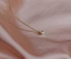 "This vegan pearl necklace is delicate and minimal, perfect for everyday wear jewelry. This pearl charm necklace is classic and timeless, and makes a lovely bridesmaid gift. 💜THE DETAILS: 14K Gold-filled or Sterling Silver Chain 6mm Swarovski White Pearl Dangle 14, 15, 16, 18, 20, or 24 inches length necklace(14 = small choker, 15 = regular choker, 16 = collarbone, 18 = standard, 20 = long, 24 = extra long) *An optional 2 inch extender can be added at no charge to make your necklace adjustable Tiny Pearl Wedding Jewelry, Delicate Tiny Necklaces For Wedding, Dainty Pearl Necklace For Bridesmaid Gift, Delicate Tiny Wedding Necklaces, Tiny Minimalist Necklace For Wedding, Dainty Wedding Necklace With Simple Design, Bridesmaid Pearl Necklace, Dainty Pearl Necklace, Classic Pearl Necklace