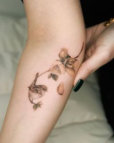 a woman's arm with flowers on it