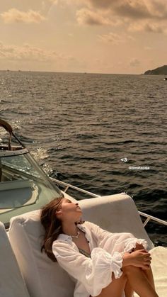 a woman laying on the back of a boat