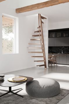 a living room filled with furniture and a spiral staircase