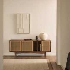 a living room with white walls and wooden furniture