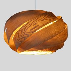 a wooden light hanging from the ceiling with woodgrain on it's side