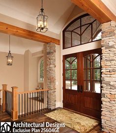 an entry way with stone pillars and wooden doors, surrounded by wood trimmings