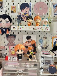 several anime dolls are on display in a store with other toys and decorations behind them