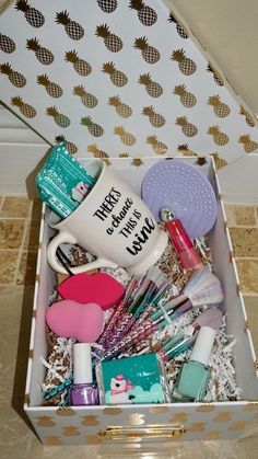 a box filled with assorted items on top of a tiled floor