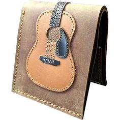 a brown leather wallet with a guitar on it's front and back flaps