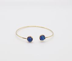 The Druzy Navy Blue Stone End Cuff Bracelet is a lightweight bracelet that is great to use for stacking with other bracelets. It is a beautiful bracelet that will add a touch of elegance to any outfit. Elegant Blue Wrap Bracelet As Gift, Elegant Blue Wrap Bracelet As A Gift, Blue Stackable Jewelry As Gift, Elegant Blue Stackable Crystal Bracelet, Adjustable Blue Stackable Wrap Bracelet, Adjustable Blue Stackable Stretch Bracelet, Blue Adjustable Stackable Stretch Bracelet, Blue Stackable Bracelets As Gift, Blue Stackable Bracelets For Gift