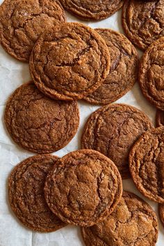 a bunch of cookies sitting on top of a piece of paper next to each other