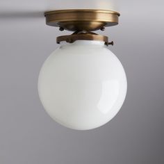 a white light hanging from a ceiling fixture