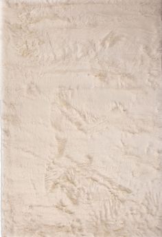 an area rug with white fur on it