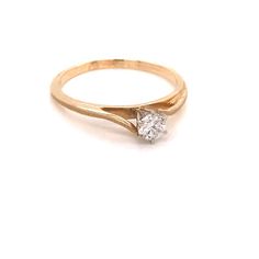 a yellow gold ring with a single diamond